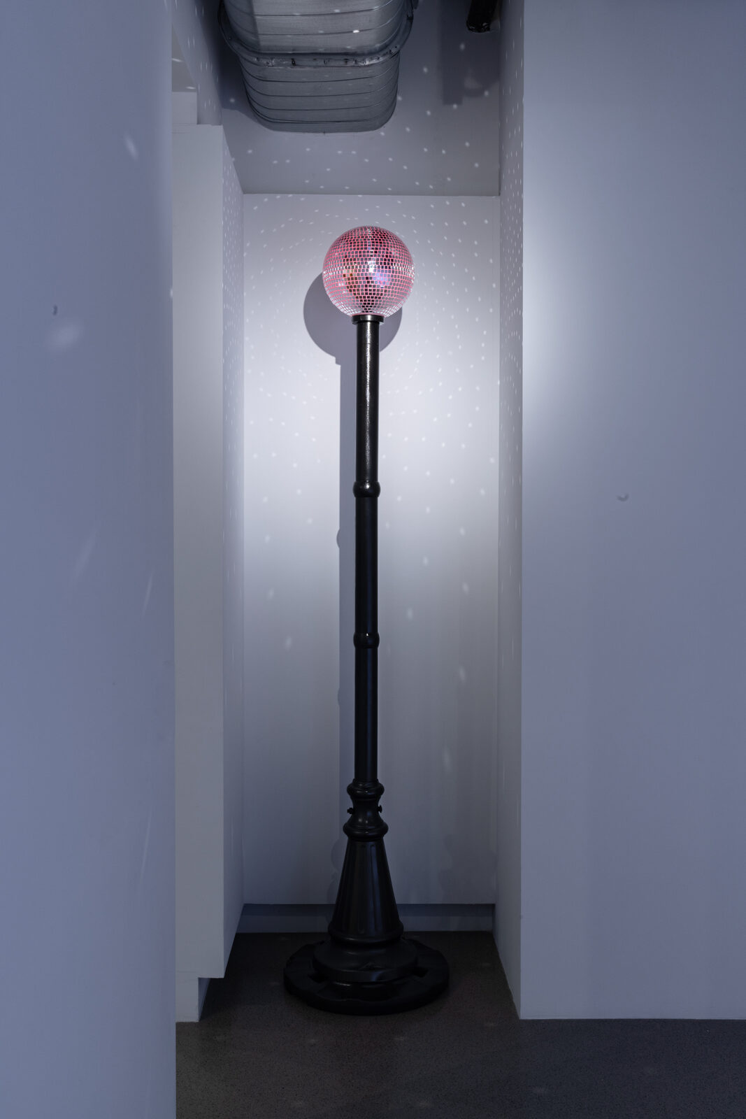 Beacon, a mirrored ball glowing red atop a found light pole