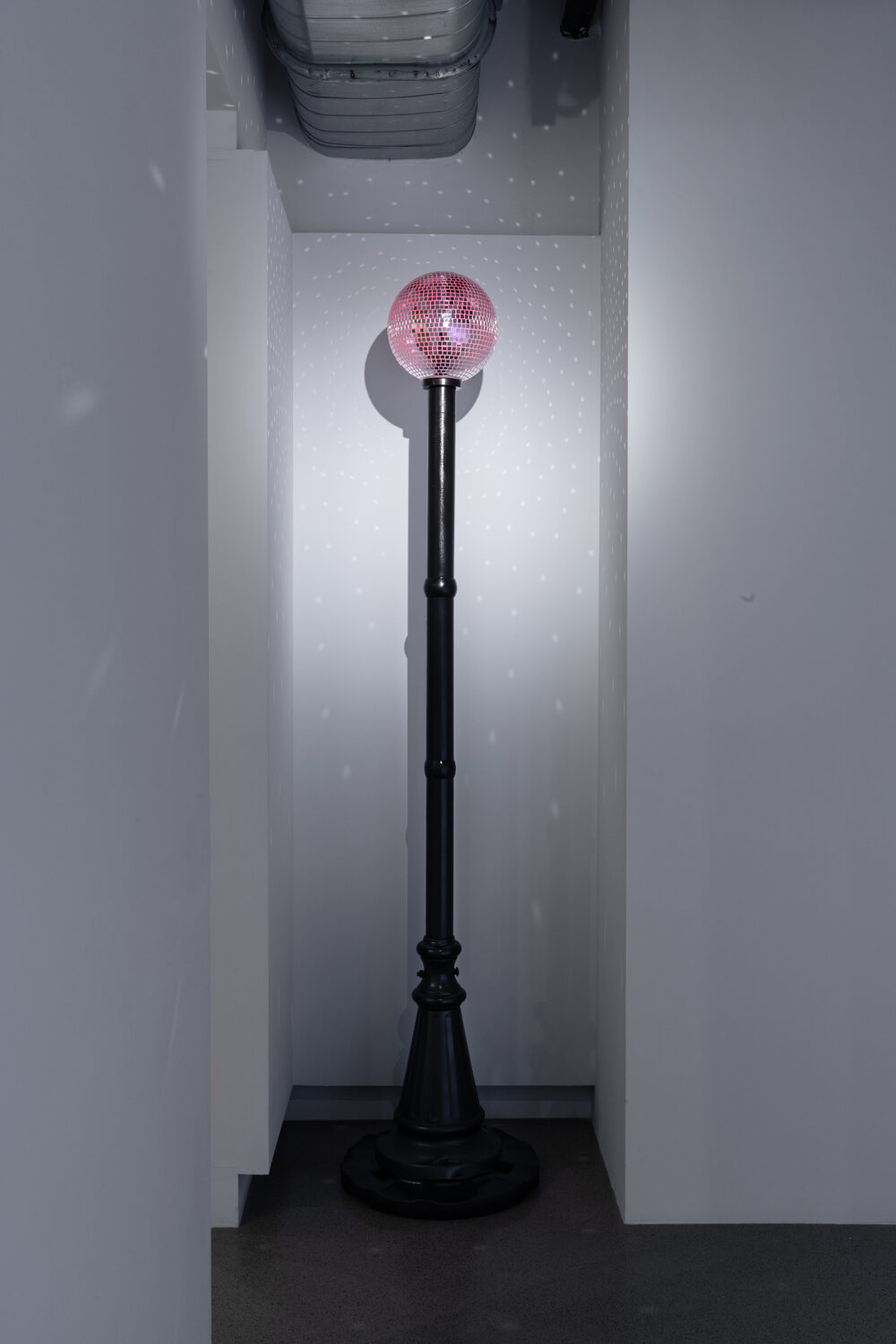 Beacon, a mirrored ball glowing red atop a found light pole