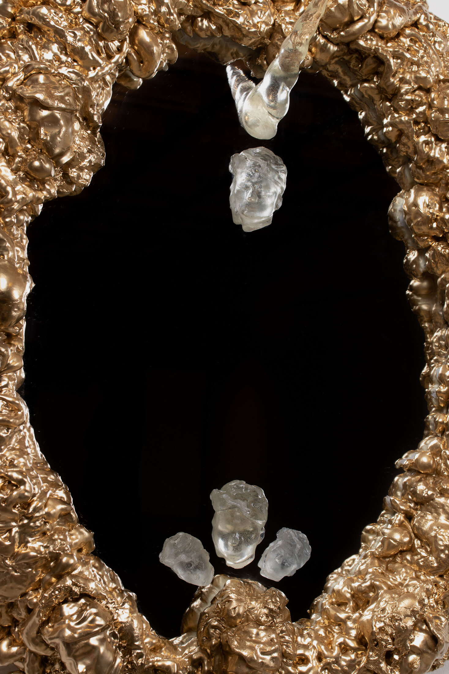 Self-Portrait The Vanity, a gilded Rococo-style mirror frame studded with resin casts of the artist's head